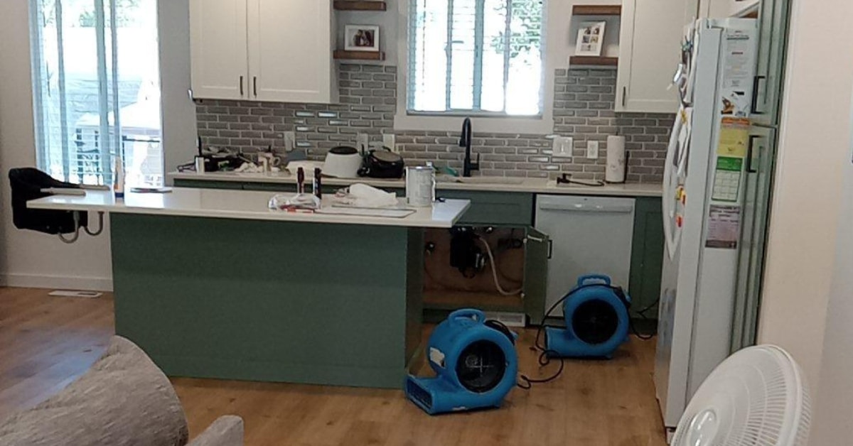 Kitchen floor with water damage caused by leaking dishwasher