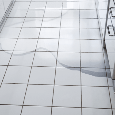 Technician using drying equipment for dishwasher water leak cleanup